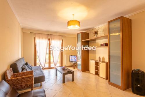 a living room with a couch and a table at Lux apartment - one bedroom , living room , kitchen , bathroom - for 1 to 7 people, also for parties & gatherings up to 25 people, only 15 minutes from Thessaloniki city center and 8' minutes from Thessaloniki airport in Néon Rýsion