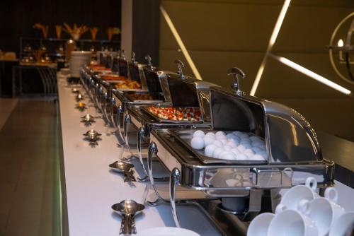 a buffet line with eggs and other pastries at Executives Hotel - KAFD in Riyadh