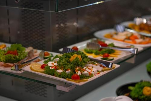 a buffet with several plates of food on display at Executives Hotel - KAFD in Riyadh