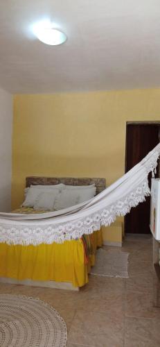 a bed with a white canopy in a room at Sítio Vale da Serra in Maranguape