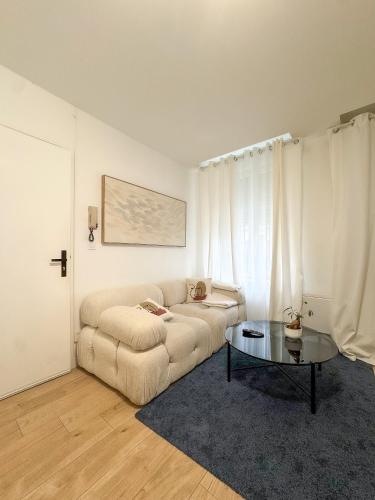 un salon avec un canapé et une table dans l'établissement Héra, à Caen