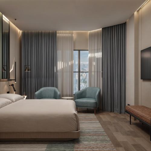 a hotel room with a bed and two chairs at Radisson Hotel Jeddah Tahlia in Jeddah