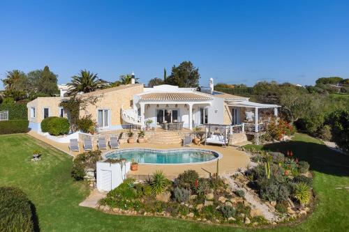 an aerial view of a house with a swimming pool at Cliffside Boho Villa in Luz