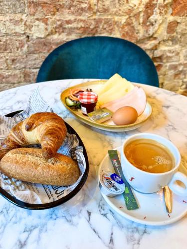 a table with a plate of bread and a cup of coffee at PJs Hostel in Groningen