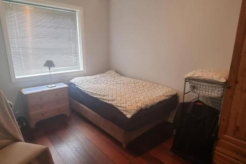 a small bedroom with a bed and a window at Apartement in Drammen close to the main city in Drammen