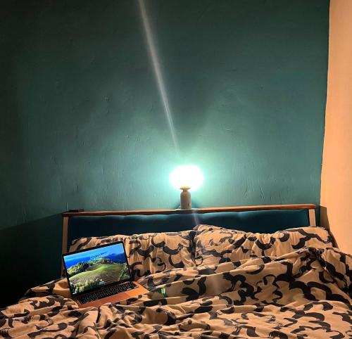 a laptop computer sitting on top of a bed at Perla Azzurra - Forte dei Marmi - Cinque Terre in Montignoso