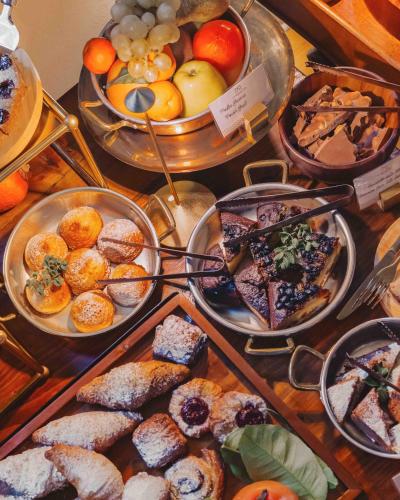 a table filled with different types of pastries and desserts at La Monastica Resort & Spa in Borgo a Buggiano