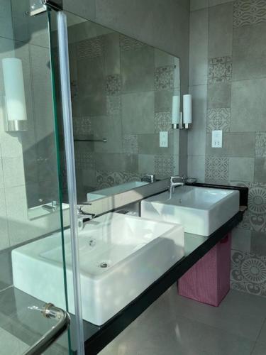 a bathroom with a sink and a mirror at Sandy Shores in Nilaveli