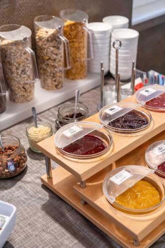 a table topped with different types of food on shelves at Astoria City Resort in Essen