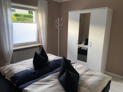 a bedroom with a bed with pillows on it at Ferienhaus Mayer Dahn Wohnung Neven in Dahn