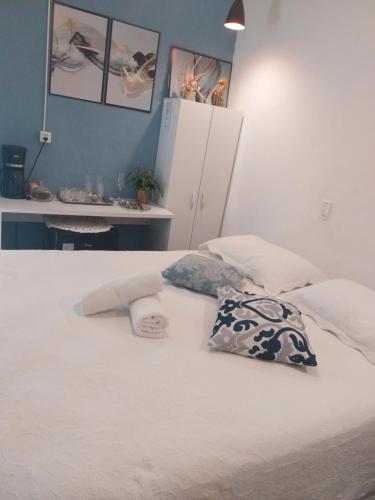 a bedroom with a bed with two pillows on it at Casa da vanuze in Holambra