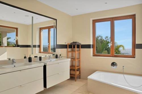 a bathroom with two sinks and a large mirror at Villa -Heated pool -Amazing view -Ideal for groups in Mijas