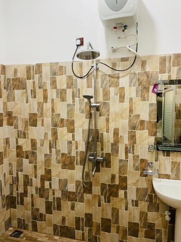 a bathroom with a shower and a sink at 07th Heaven Villa in Tangalle