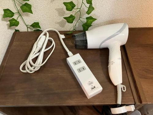 a hair dryer and a blow dryer on a table at Private & Cozy Studio Okegawa in Okegawa