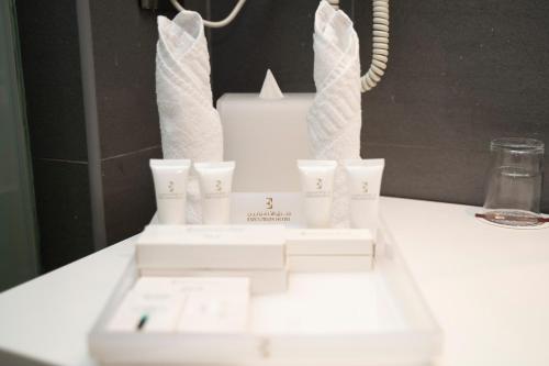 a white wedding cake sitting on top of a table at Executives Hotel - KAFD in Riyadh