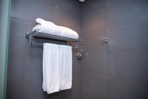 a bathroom with a towel rack with towels at Executives Hotel - KAFD in Riyadh