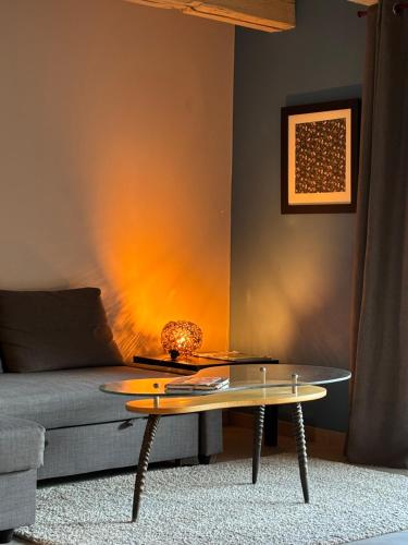 a living room with a couch and a table at La grange de Sophie in Berstett