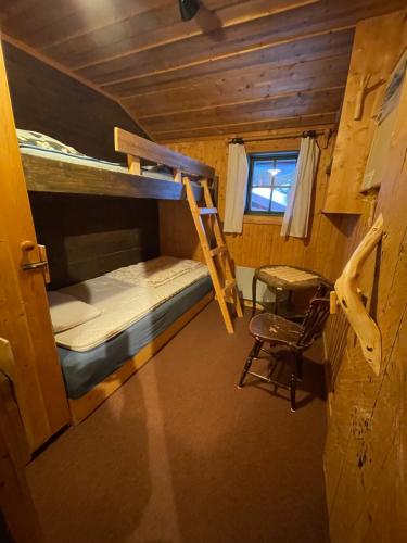 a room with two bunk beds and a chair at Åre, Trillevallen stuga Privaten in Undersåker