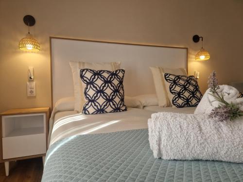 a bedroom with a large bed with pillows on it at Hotel Bodegón de Peñíscola in Peñíscola