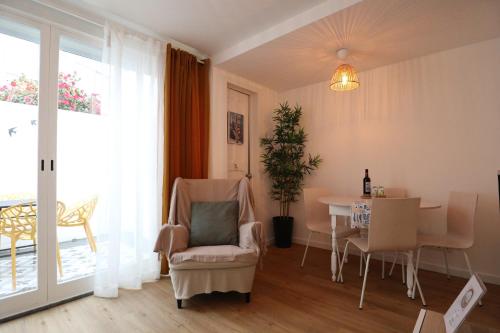 a living room with a table and a chair at Giraffe House in Lisbon
