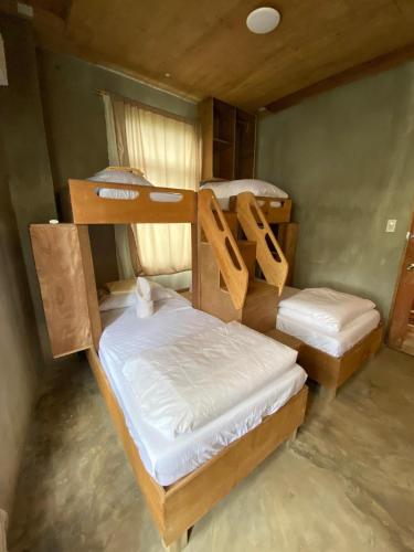 a room with two bunk beds in it at Ohayo Siargao in General Luna