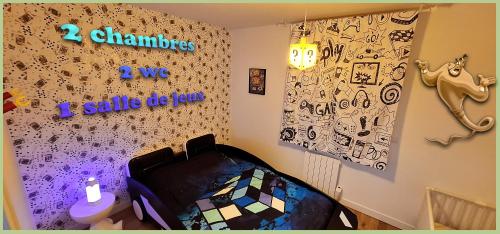 a childs room with a wall covered in graffiti at 15' de Disney maison à thème avec SALLE DE JEUX privée 6 couchages 2 wc in Voulangis