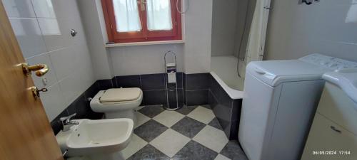 a small bathroom with a toilet and a sink at Casa vacanze Mare Monti in Grottammare