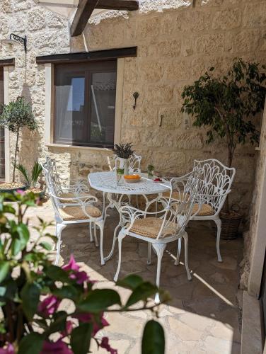 a white table and chairs on a patio at Passo del Mattino in Locati