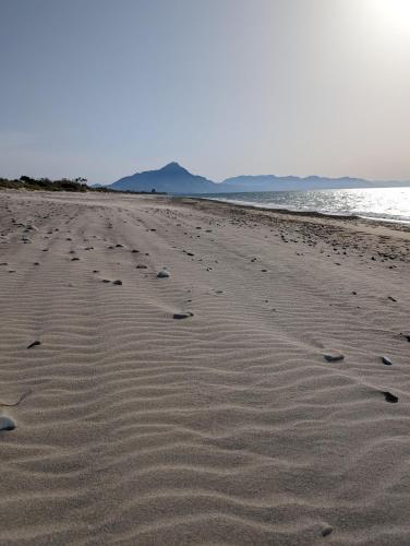 a group of footprints in the sand on a beach at Passo del Mattino in Locati