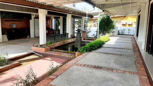 a front porch of a house with a pond at WHG Homestay, Paya Berenjut Kemaman in Cukai