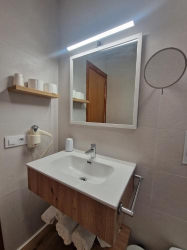 a bathroom with a sink and a mirror at Hotel Bodegón de Peñíscola in Peñíscola