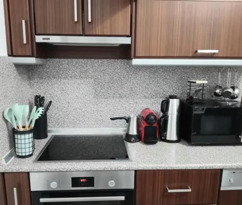 a kitchen counter with a sink and a microwave at Luxury Villa Ntina in Maronia