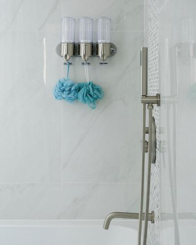 a bathroom with a shower with four lights on the wall at Ocean Pearl - Deluxe OceanView Heated Pool in Vila Franca do Campo