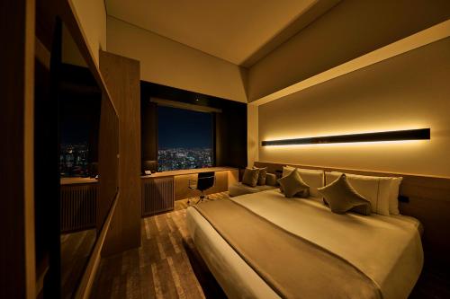 a hotel room with a large bed and a window at The Royal Park Hotel Iconic Tokyo Shiodome in Tokyo