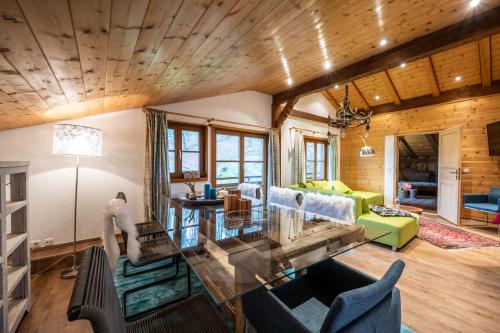 a living room with a glass table and blue chairs at Ferienwohnung Lichtblick in Oberstdorf