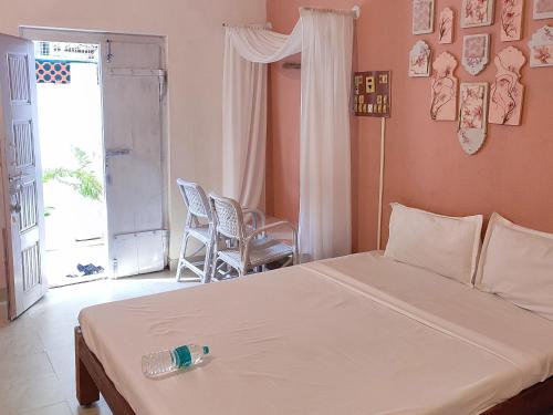a bedroom with a bed and a room with a window at Vanam Soulful Stays in Puducherry