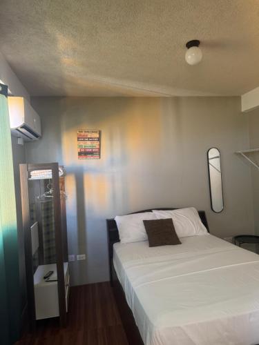 a bedroom with a bed with a white bedspread at One bedroom Apartment Rental in Paix Bouche