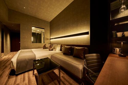 a hotel room with a bed and a couch at The Royal Park Hotel Iconic Tokyo Shiodome in Tokyo