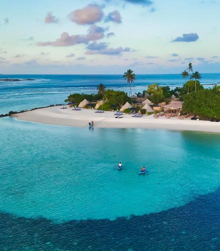 an aerial view of a beach with two boats in the water at The MAVERICK SURF AND DIVE BOUTIQUE HOTEL - Book 10 Nights and get 1 Free Night - Free Speed Boat Service - Kids Stay Free in Laamu