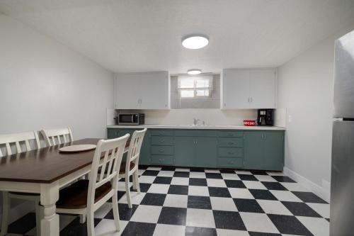 a kitchen with a table and some chairs and a counter at Basin Staycation in Vernal