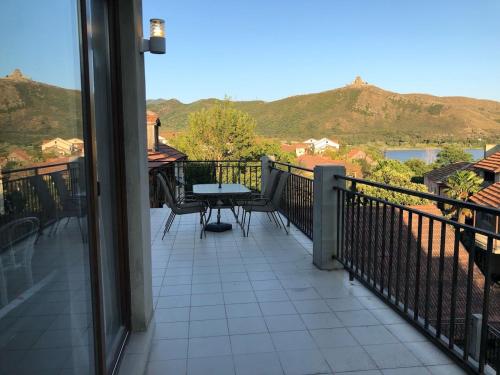 a balcony with a table and a view of the mountains at Apartment 17 in Mtskheta