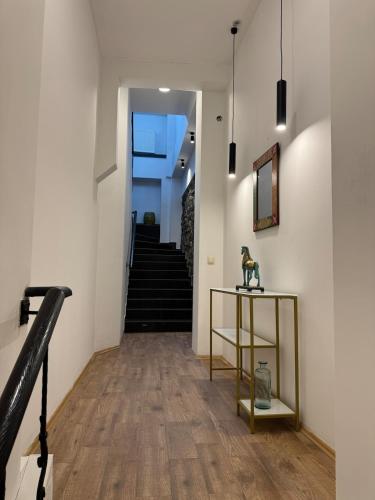 a hallway with stairs and a table with a statue on it at Apartment 17 in Mtskheta