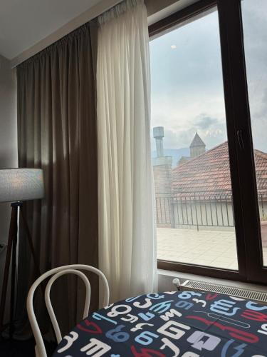 a bedroom with a window with a view of a roof at Apartment 17 in Mtskheta