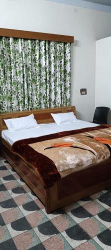 a large bed in a room with a window at The Ganga Home Stay in Prayagraj