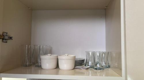 a shelf with vases and glasses on it at AFORREST Family Resort in Qusar