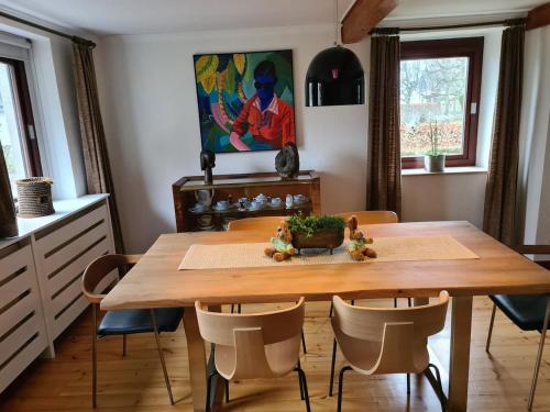 a dining room with a wooden table and chairs at Haus Päsch near lake with heated jacuzzi sauna in Butgenbach