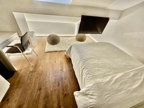 a bedroom with a bed and a desk with a computer at Cosy private room in Lausanne center in Lausanne