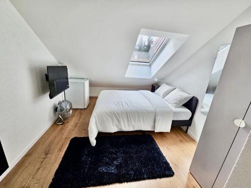 a small bedroom with a bed and a window at Cosy private room in Lausanne center in Lausanne