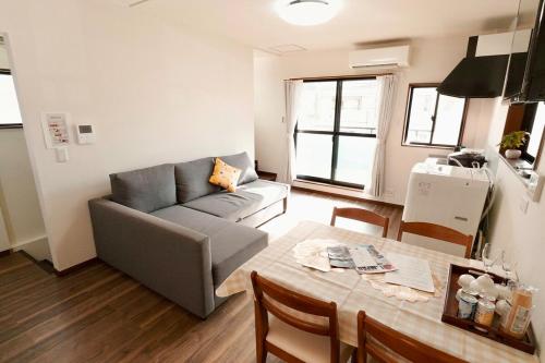 a living room with a couch and a table at Namba shiokusa in Osaka