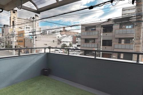 a balcony with a view of a city at Namba shiokusa in Osaka